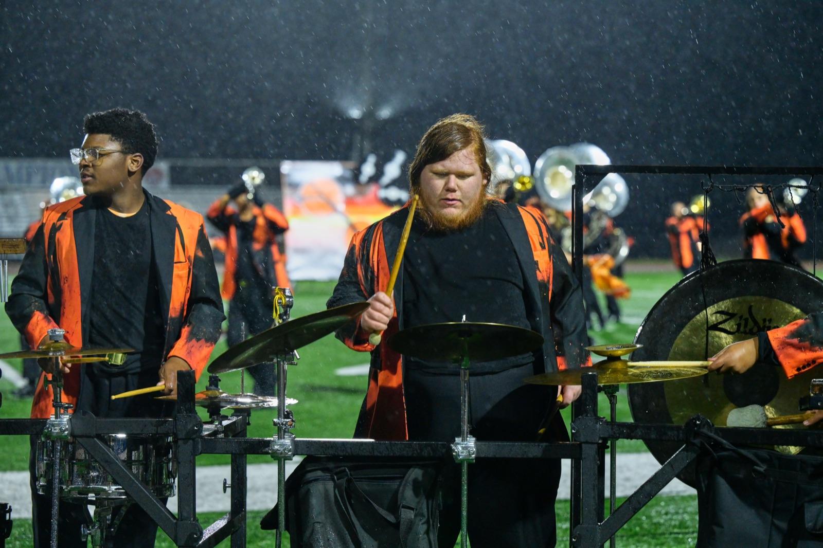 Drumline cymbal player in the rain
