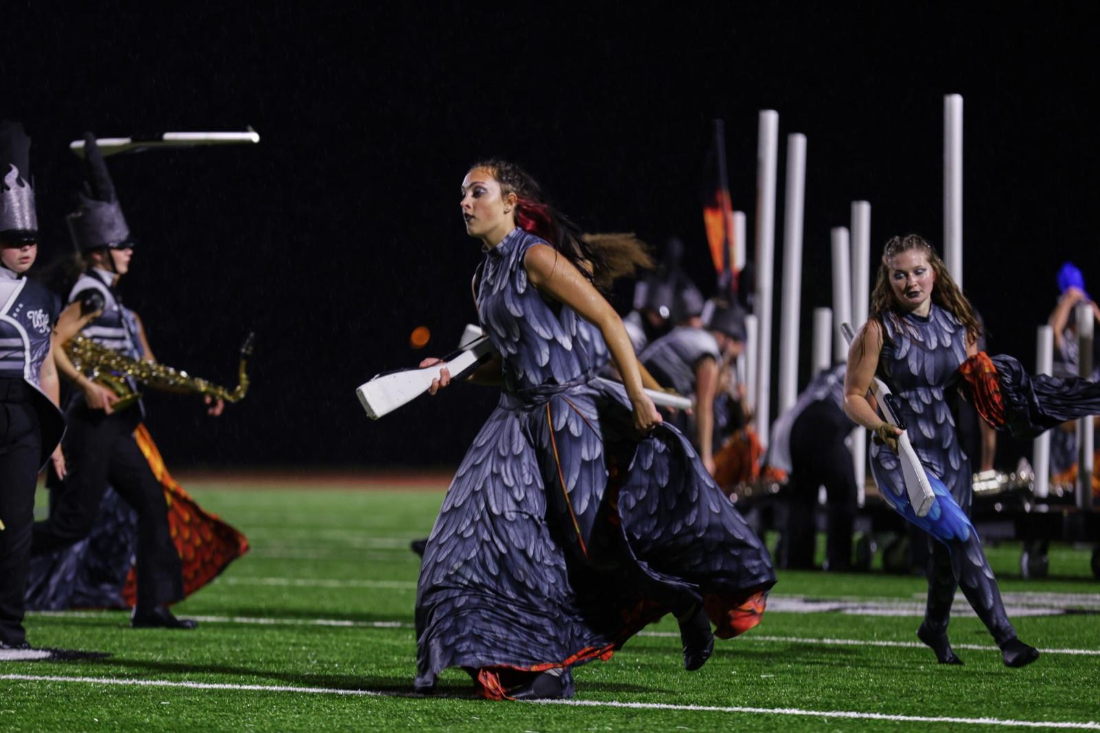 Guard sprinting across the field with silks flying