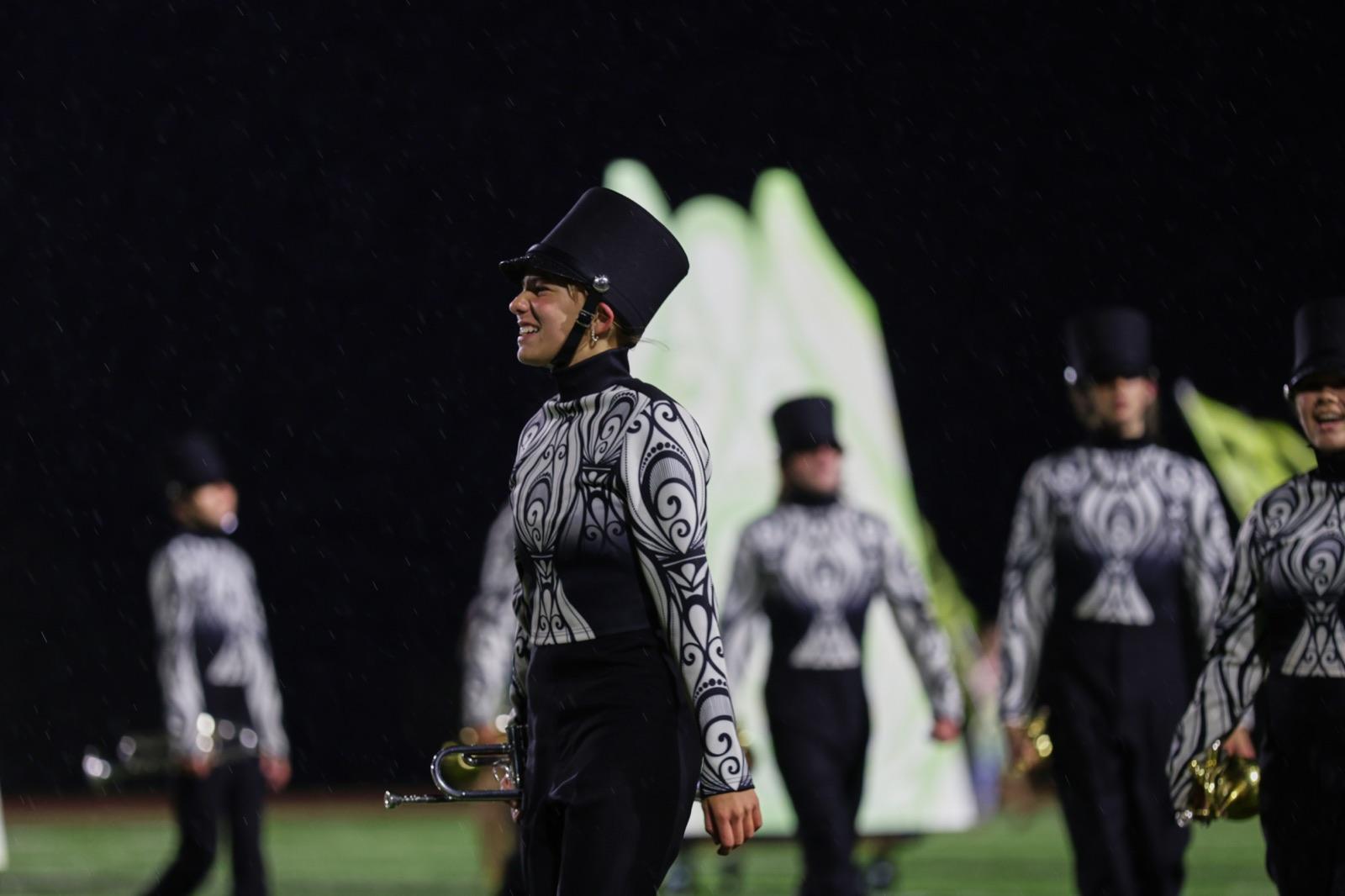 Flutes playing through the rain with ponchos on